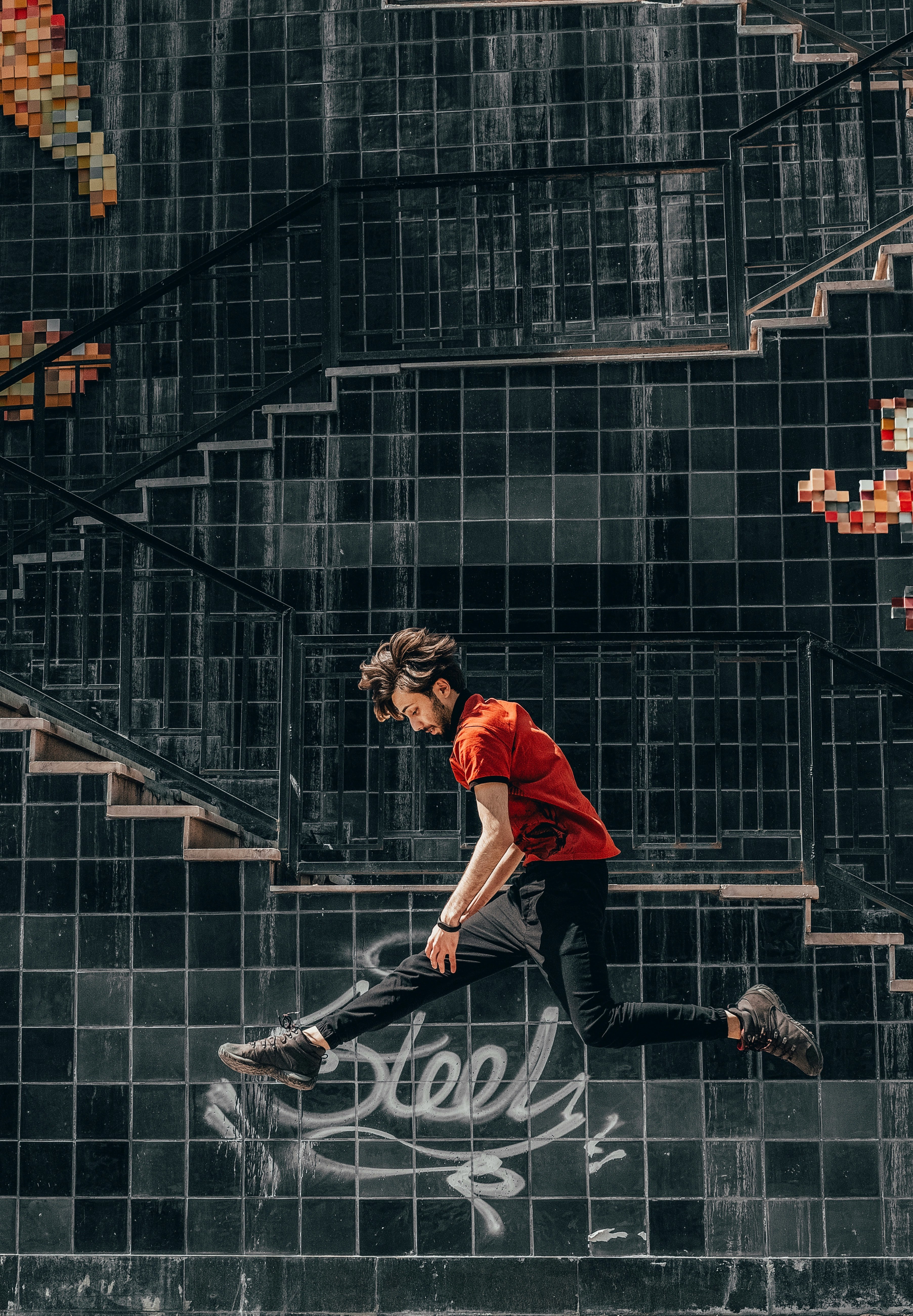 man jumping in front of building